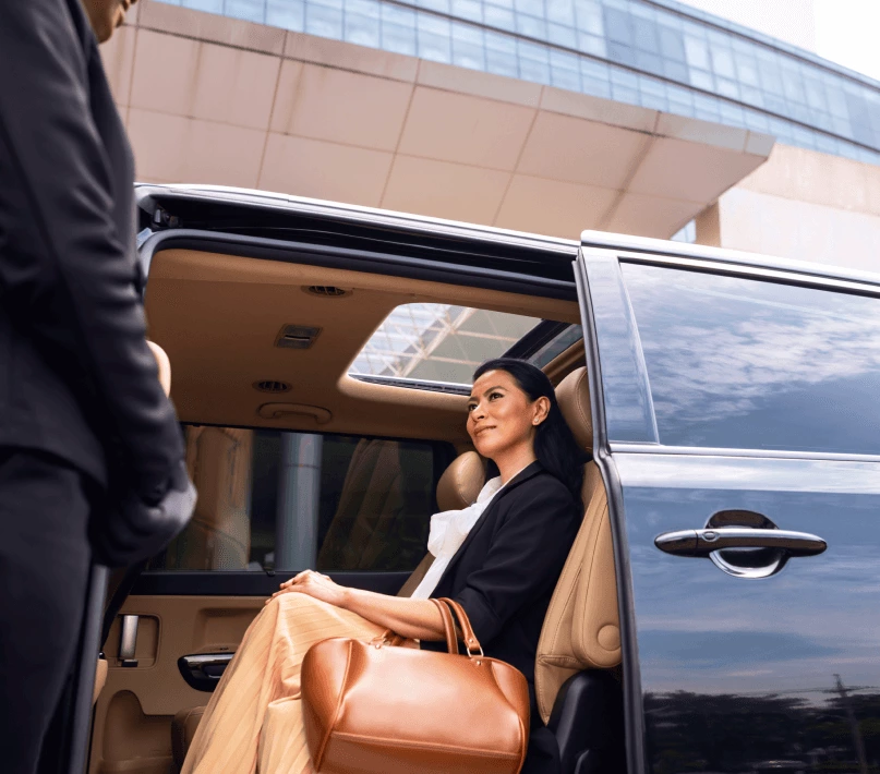 A business woman sitting in a luxury van