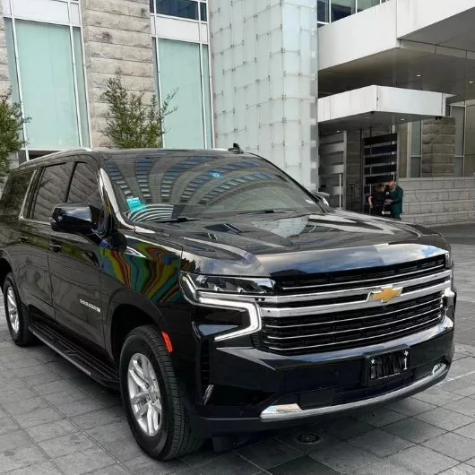 A luxury black chevy suburban
