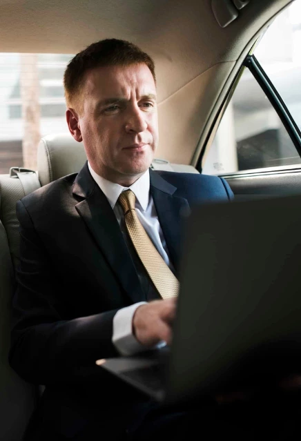 A business man travelling in a luxury sedan