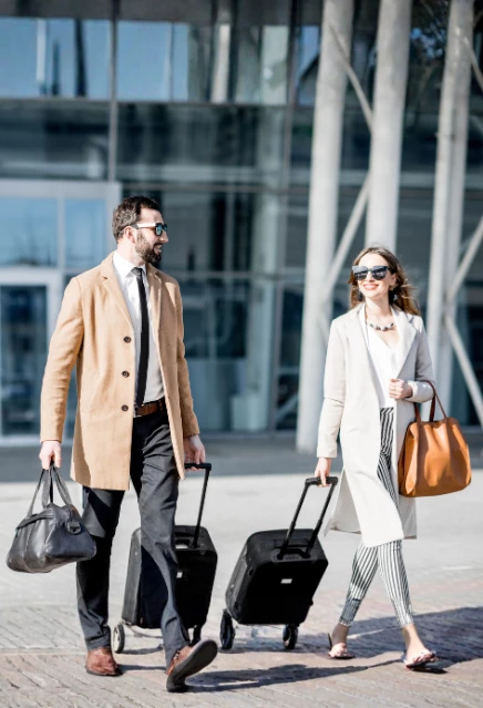 A couple at dfw airport moving towards their luxury car ride